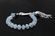 Sterling silver and gem bracelet.  Gems: aquamarine and moonstone.  White Orchid Studio vanilla bean clasp and floral bead cap.  Approximate length 6.75."  