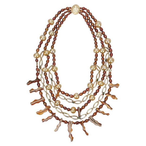 This pearl, spessartite garnet, tourmaline, and gold bib necklace proves it is possible to dress up and down with great jewelry.  The longest strand is 22.”