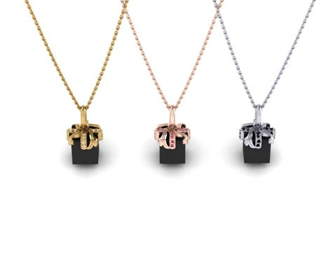 For Love: A Charm of Gold and Diamonds Wrapped Around a Polished, Black Spinel Gift Box