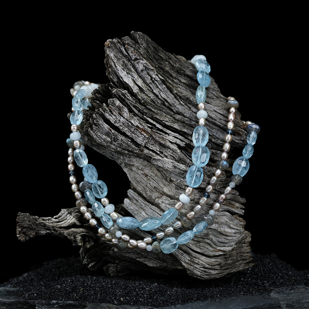 14kt white gold 3-strand necklace. Gems: pearl, aquamarine, topaz, and labradorite. Approximate length 17."