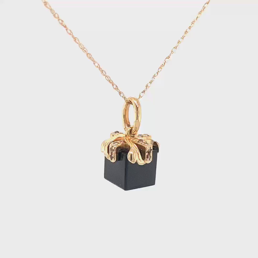 14kt yellow gold ribbon, set with 16 Champagne diamonds (approx .11 cts) set on a black spinel cube.