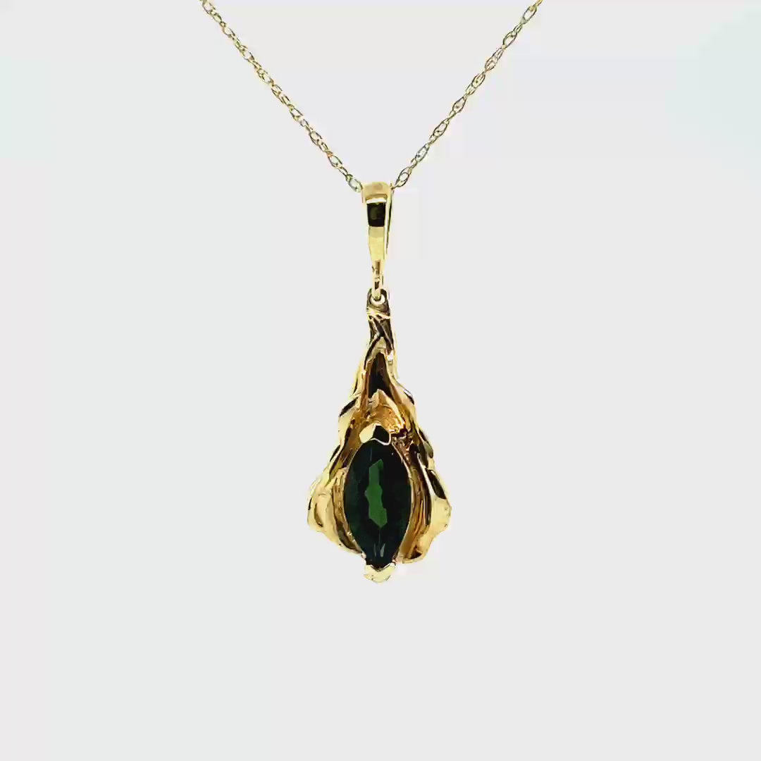14kt yellow gold charm, designed as a leaf. Marquis cut, green tourmaline (1.01 cts.).