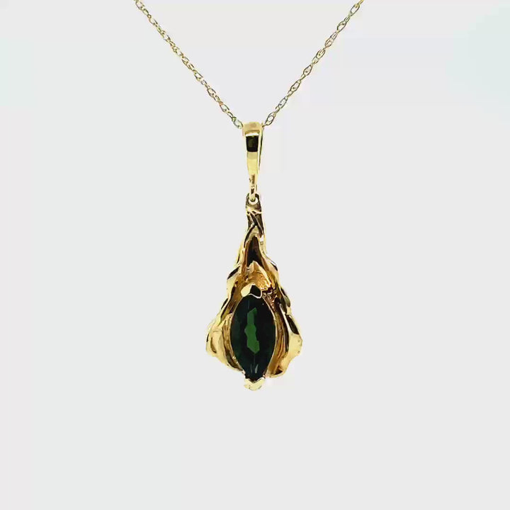 14kt yellow gold charm, designed as a leaf. Marquis cut, green tourmaline (1.01 cts.).