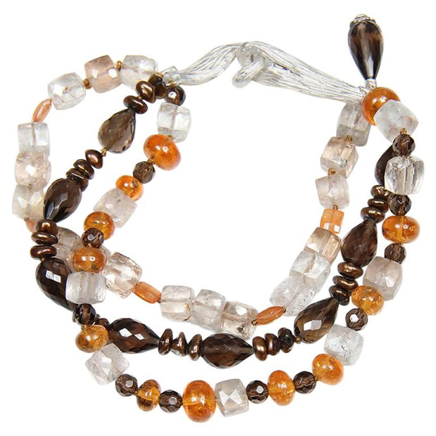 Precious topaz, smoky quartz, mandarin garnet, and Keshi pearl 3-strand bracelet. Sterling silver, vanilla bean clasp. 7.75”