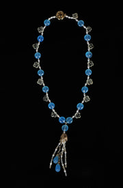 14kt yellow gold choker necklace (16”) with a tassel (3”).  Gems: blue chalcedony, carved scapolite, white topaz, and pearl. 