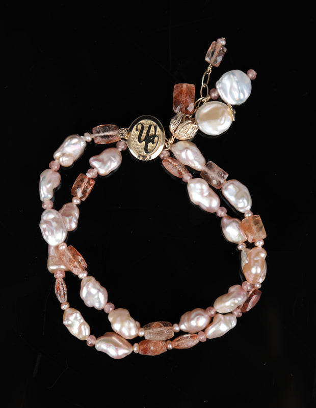 A pearl, rhodochrosite, sunstone, and gold bracelet. 14kt yellow gold White Orchid Studio logo clasp and a custom bead cap.   7.5”
