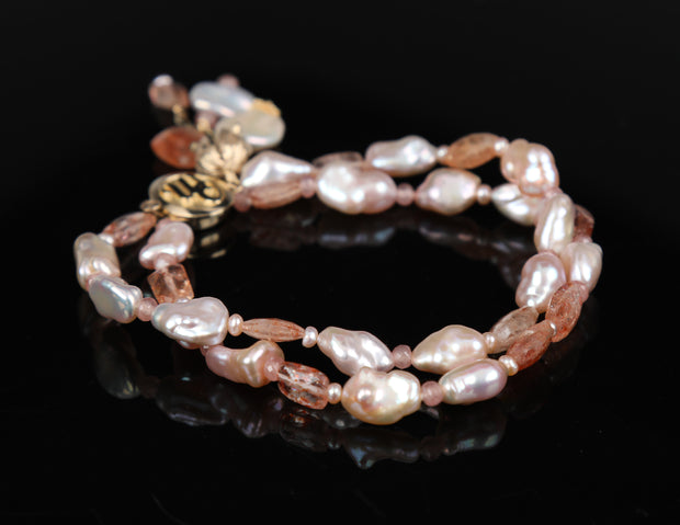 A pearl, rhodochrosite, sunstone, and gold bracelet. 14kt yellow gold White Orchid Studio logo clasp and a custom bead cap.   7.5”