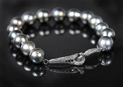 14kt white gold.  Gems: black south sea pearl and black diamonds. White Orchid Studio’s vanilla bean clasp is antiqued to enhance the texture. Approximate length 8.”