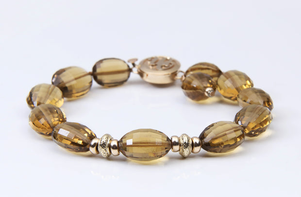Gem and gold bracelet. Golden quartz glows next to 14kt yellow gold rondelles and the White Orchid Studio logo clasp. 7"