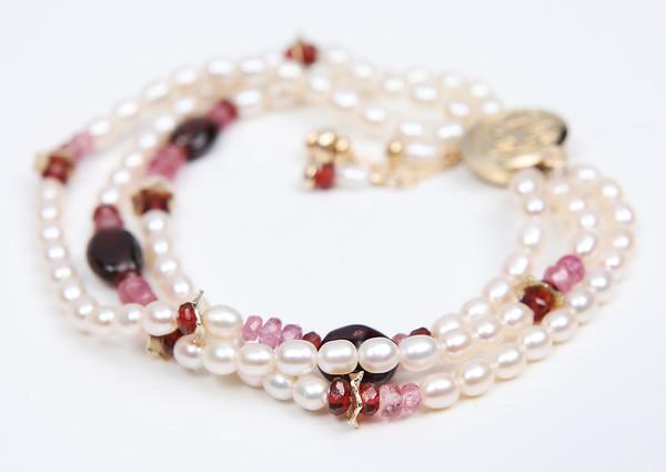 A pearl, pink tourmaline, ruby, garnet, and gold bracelet.  14kt yellow gold. 7.5”