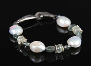 Sterling silver and gem bracelet.  Gems: Ceylon moonstone, freshwater pearls, and moss aqua.   White Orchid Studio’s vanilla bean clasp and spacers.  Approximate length 9."
