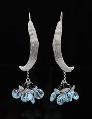 Sterling silver.  Gems: sky-blue topaz, silver Keshi pearl, and black spine.  White Orchid Studio’s ear wire resembles a vanilla bean. An approximate length of 3.5.”