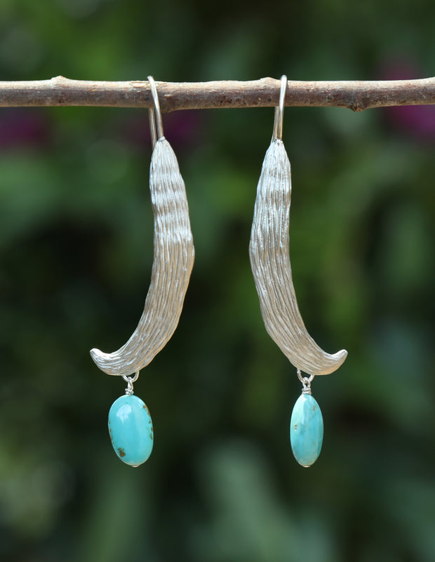 Natural turquoise.  A sterling silver custom, vanilla bean ear wire.  An approximate length of 2.5.”