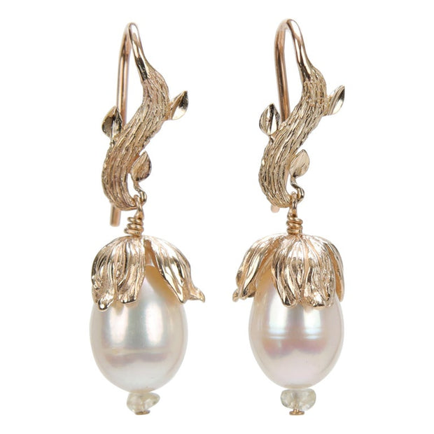 14kt yellow gold.  Gems: white freshwater pearls and Songea sapphires.  White Orchid Studio vanilla leaf ear wire and bead cap.  Approximate length is 1.5.”