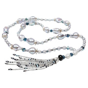 Sterling silver.  Gems: freshwater pearl (baroque and rice shapes), kyanite, teal to blue sapphires, topaz, and labradorite.  White Orchid Studio’s spacers and floral bead cap.  Approximate length 45.5."  