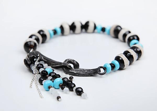 Turquoise, banded agate, and onyx bracelet.  Sterling silver vanilla bean clasp, bead cap and multi-strand tassel.  7.5”  