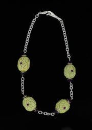 Sterling silver: textured silver chain. Gems: Mojave turquoise, Malaya and almandine garnet, and amethyst. White Orchid Studio’s vanilla bean clasp and wave spacers. Approximate length: 19.5”