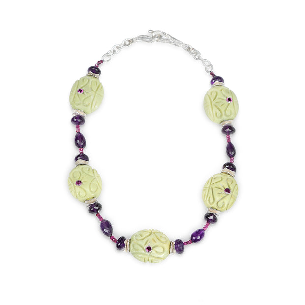 Sterling silver: textured silver chain.  Gems:  Mojave turquoise, Malaya and almandine garnet, and amethyst.  White Orchid Studio’s vanilla bean clasp and wave spacers.  Approximate length:  19.5”