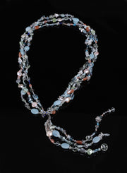 Sterling silver.  Gems: blue topaz, moonstone, aquamarine, pearls, apatite, and sapphires. White Orchid Studio’s vanilla bean lariat set deep blue sapphires. Approximate lengths 26” + 8" for the tassel.