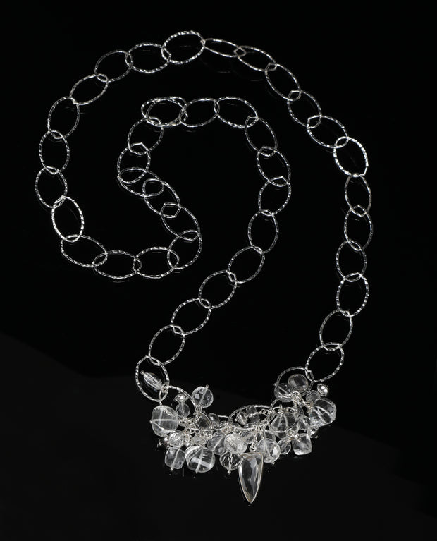 Sterling silver, opera length necklace. Gems: different shapes and sizes of clear quartz.  36”