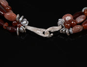 Sterling silver.  Gems:  carnelian, sunstone, and silver freshwater pearls.  White Orchid Studio’s vanilla bean clasp.  Approximate length:  18”