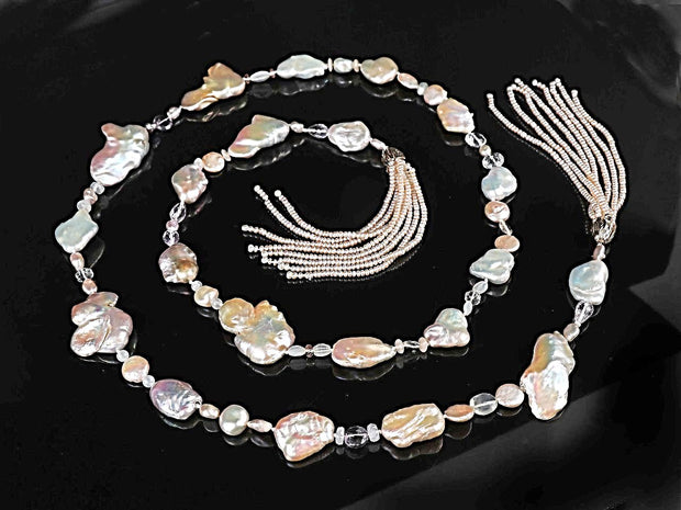14kt yellow gold.  Gems:  blush pink, freshwater Keshi pearls, light amethyst, moonstone, and Oregon sunstone. Two tassels feature button pearls. White Orchid Studio’s floral bead clasp.  Approximate length:  56”