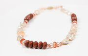 Princess necklace.  Gem necklace of Keshi and button freshwater pearls, sunstone, goldstone, and strawberry quartz.  WOS 14kt yellow gold logo clasp. 