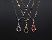 3 colors of 14kt gold charms:  white with black tourmaline, rose with rose tourmaline, and yellow with green tourmaline. 