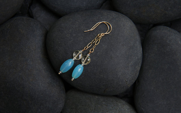 14kt yellow gold earring.  Gems: blue chalcedony, scapolite, and white topaz. The length is approximately 2.5."
